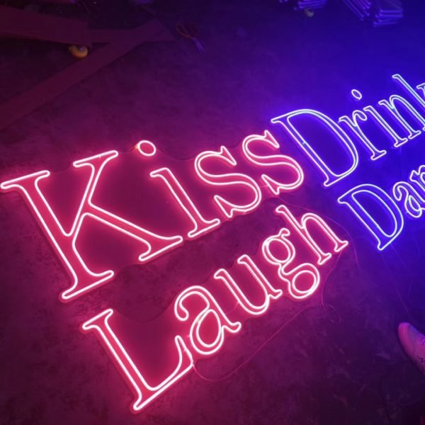 kiss drink laugh dance neon sign